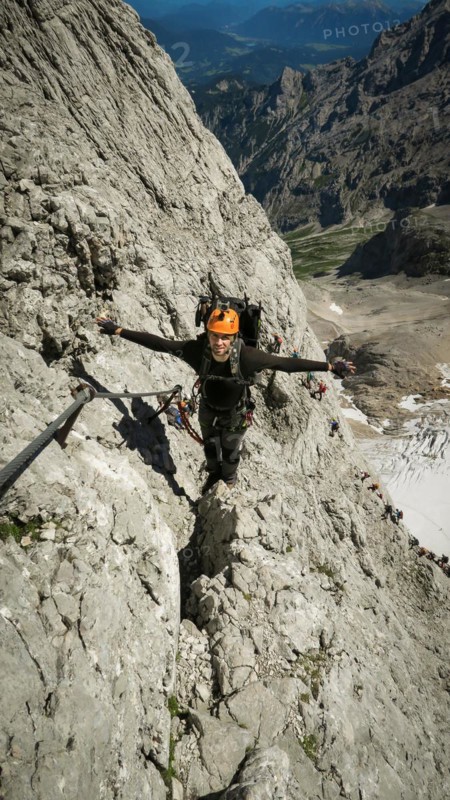 Tourist with equipment on the via ferrata trail in the alps. Zugspitze massif