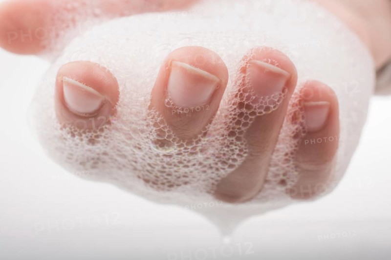 Hand washing and soap foam on a foamy background