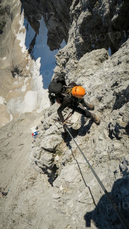 Tourist with equipment on the via ferrata trail in the alps. Zugspitze massif