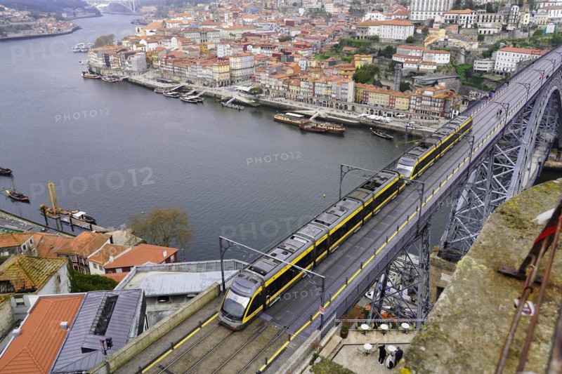 View of the Dom Luis I bridge over Douro River and terracota rooftops