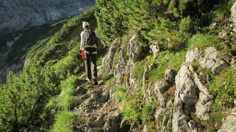 Tourist with equipment on a mountain trail in the Alps. Zugspitze massif