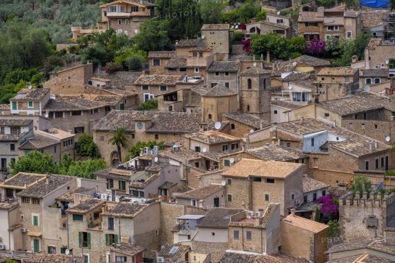 View of typical houses of the mountain village Fornalutx with church Parroquia catolica La Natividad de la virgen Maria