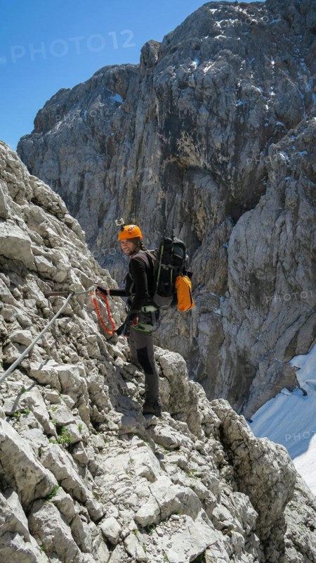 Tourist with equipment on the via ferrata trail in the alps. Zugspitze massif