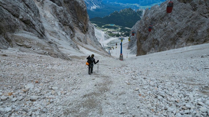 Tourist from the inventory trail in the gully with the gondola lift to Forcella Staunies