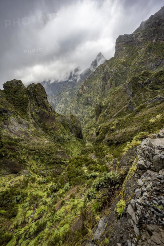 Steep cloudy mountain landscape with rock formations