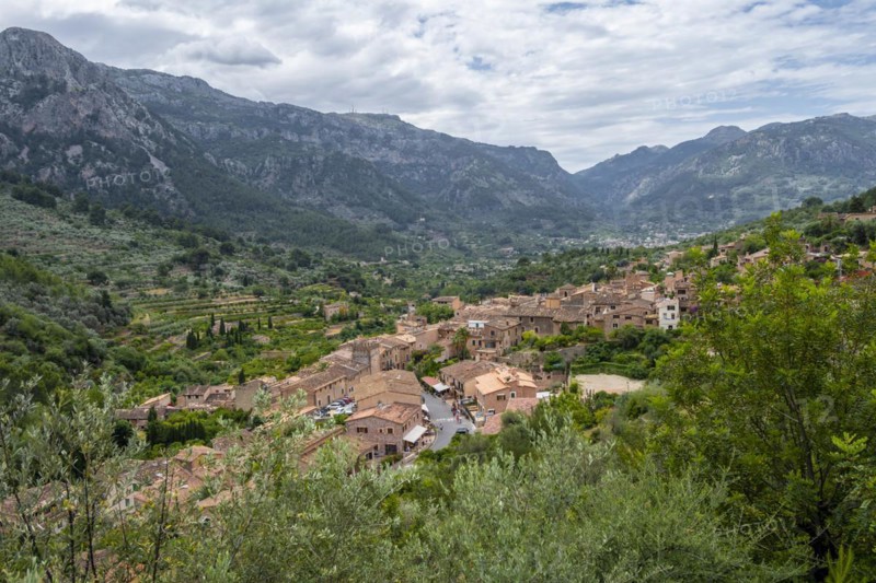 View over typical houses of the mountain village Fornalutx with mountain landscape