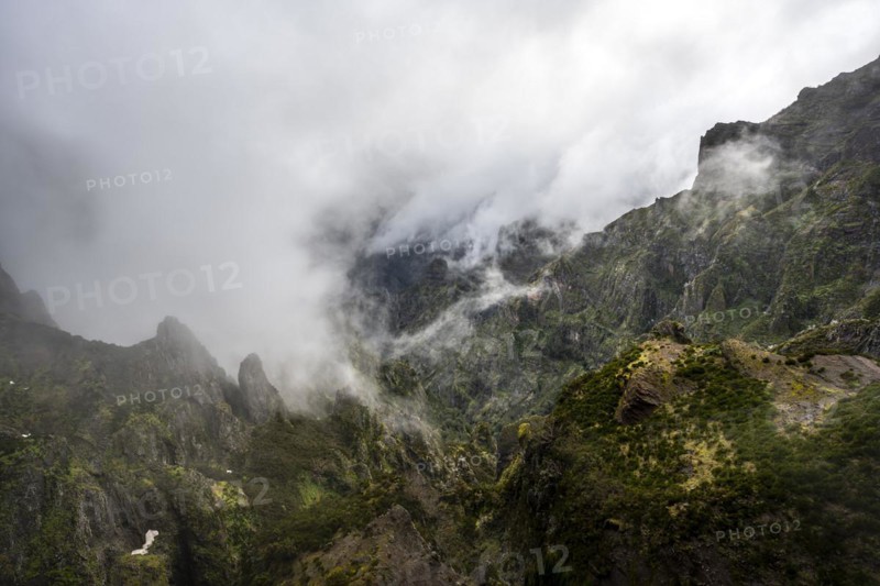 Steep cloudy mountain landscape with rock formations