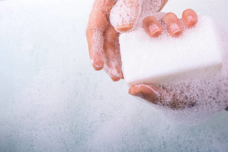 Hand washing and soap foam on a foamy background
