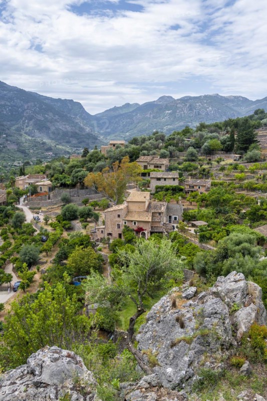 View over typical houses of the mountain village Fornalutx with mountain landscape