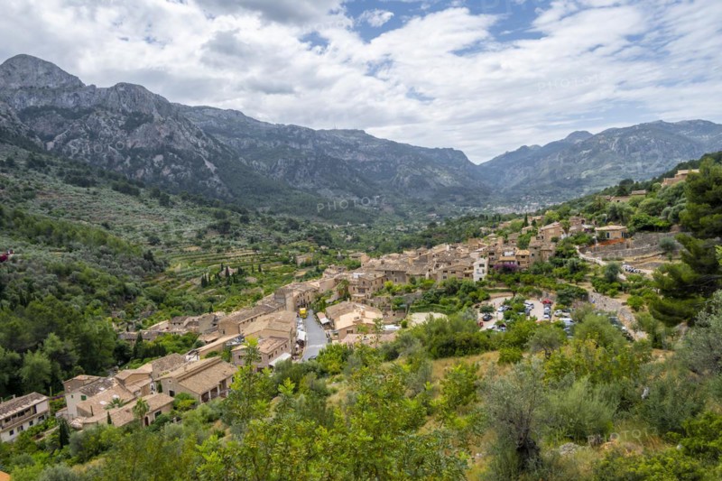 View over typical houses of the mountain village Fornalutx with mountain landscape