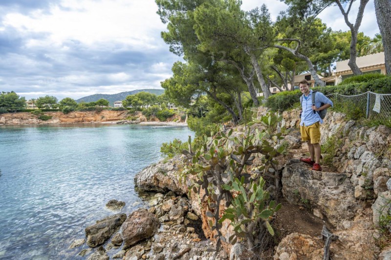 Tourist at a small rocky bay with blue sea