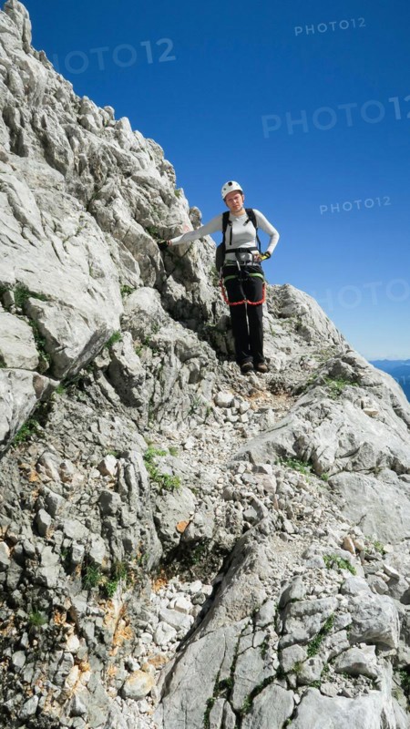 Womans crossing the via ferrata trail in the alps. Zugspitze massif