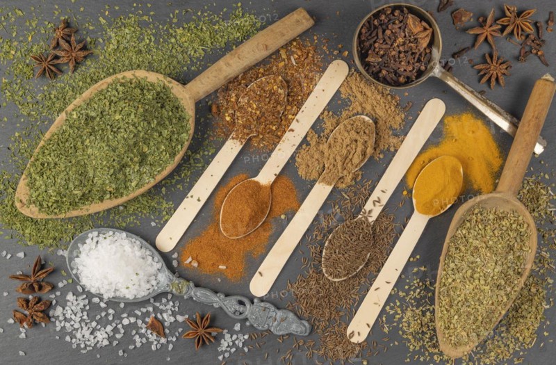 Various spices on different spoons