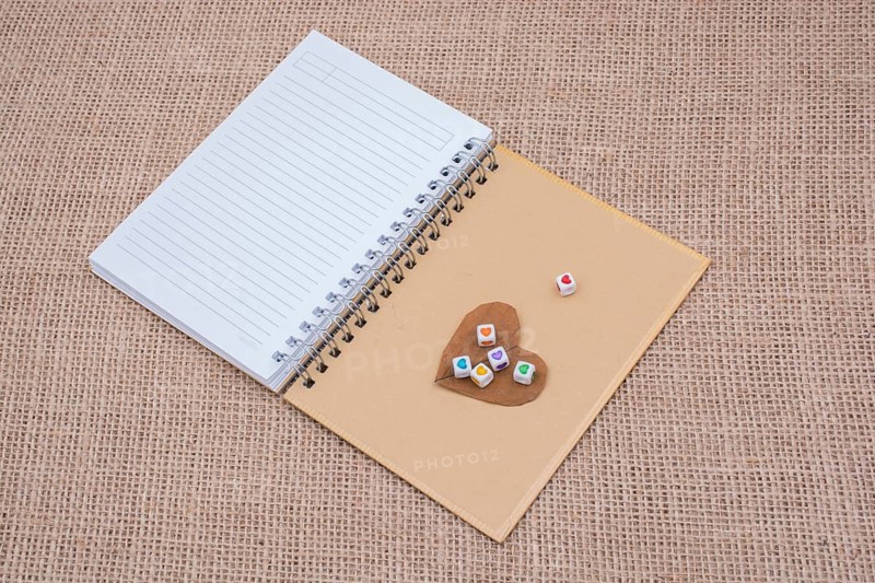 Colorful cubes with a heart on notebook on canvas