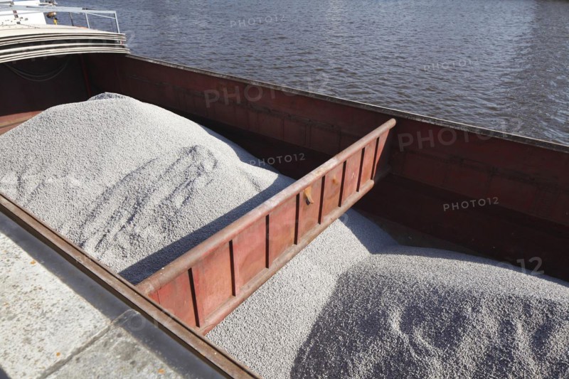 Barge in port loaded with bulk cargo