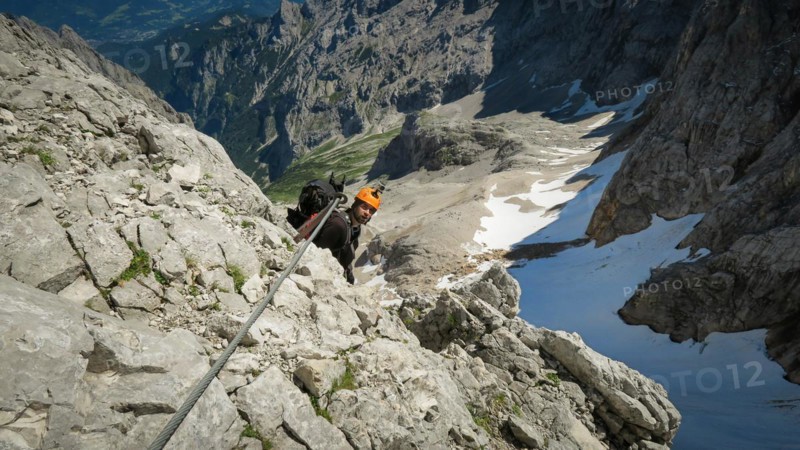 Tourist with equipment on the via ferrata trail in the alps. Zugspitze massif
