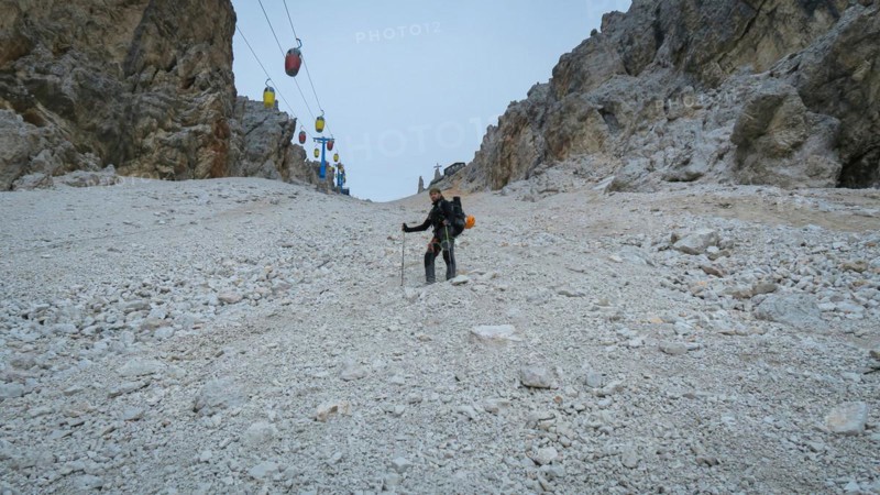 Tourist from the inventory trail in the gully with the gondola lift to Forcella Staunies
