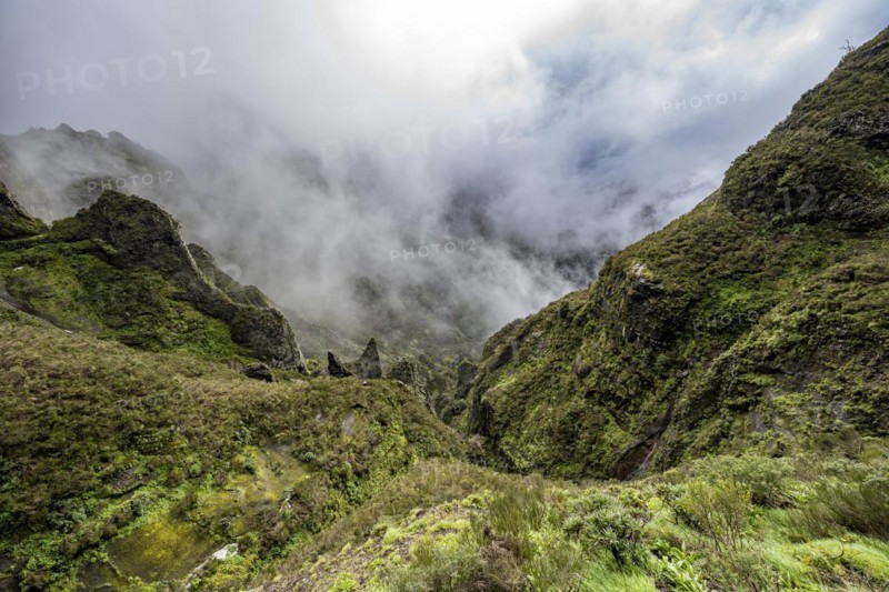 Steep cloudy mountain landscape with rock formations