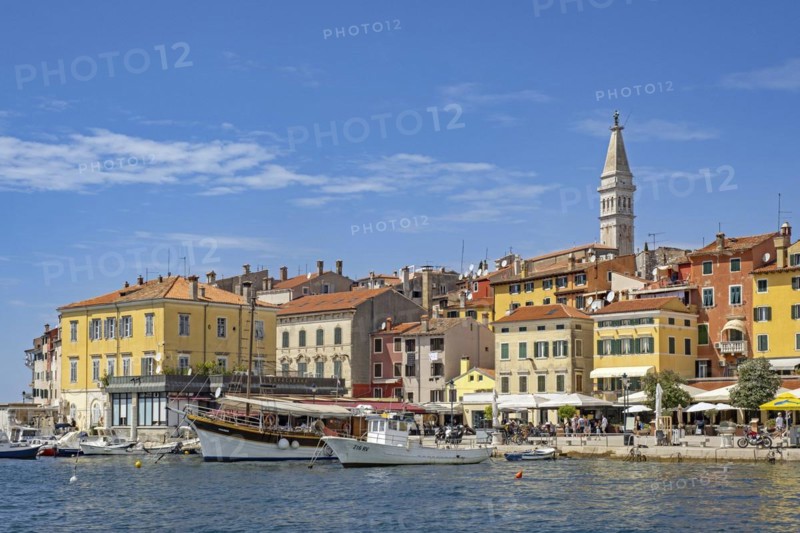 Waterfront showing boats and sailing ship in harbour of the city Rovinj