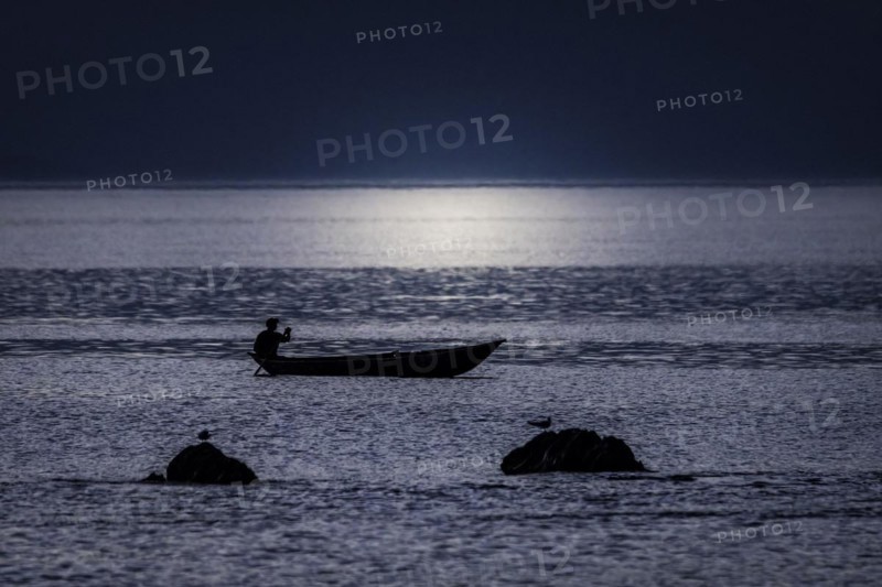A fisherman in the sunset off the coast of masoala national park in north-eastern Madagascar