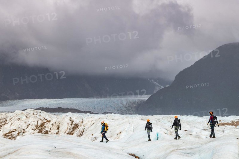 Hikers on the Exploradores glacier in the San Valentin massif