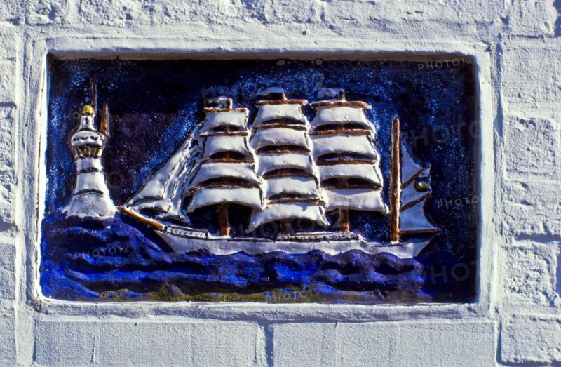 Relief panel of a sailing ship on a house wall on the island of Spiekeroog