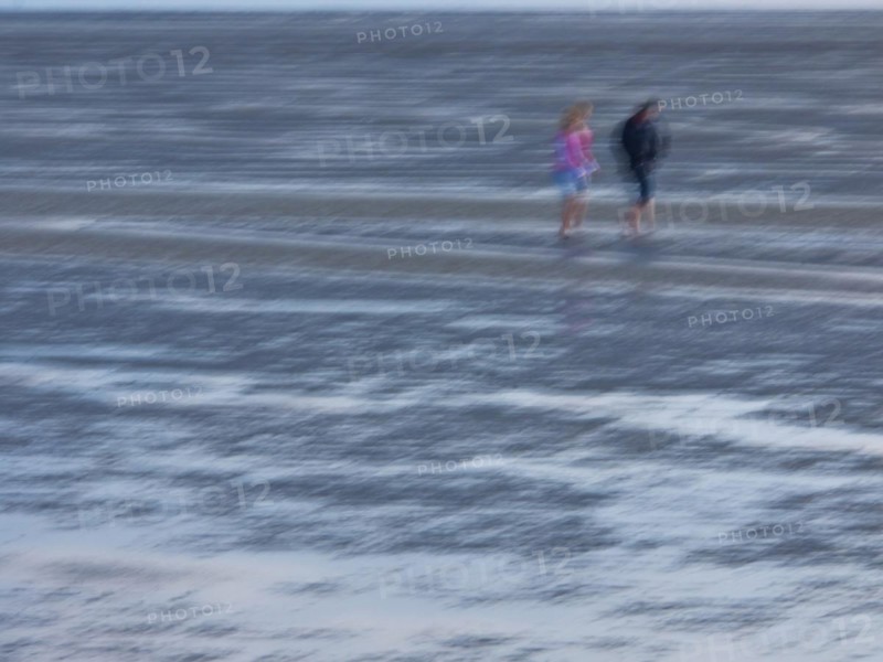 Two people in the mudflats