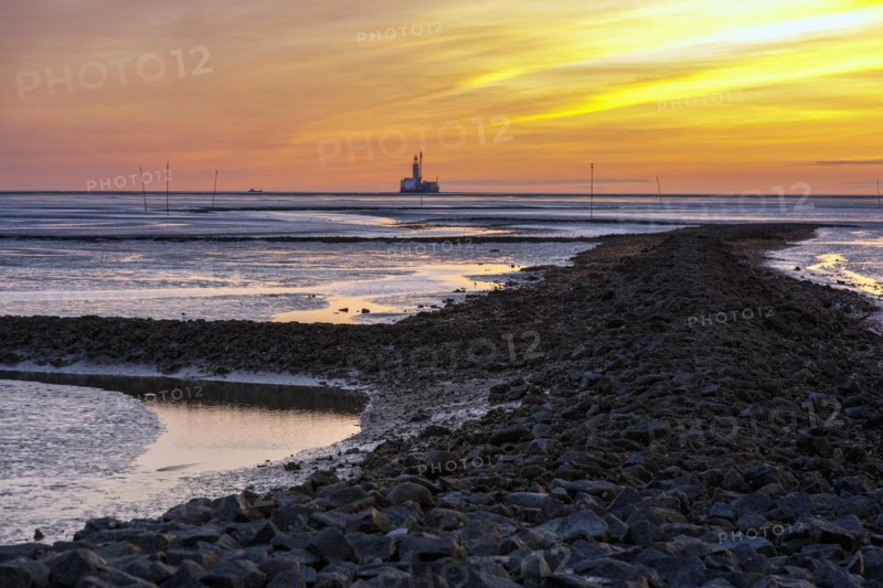 View from the Trischendamm to Germanys only drilling platform Mittelplate after sunset at low tide