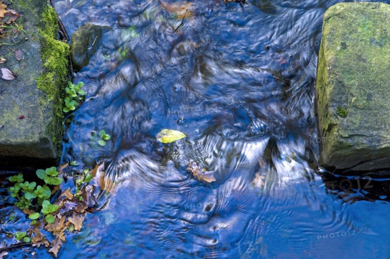 Narrows of a narrow stream with water flow and stones