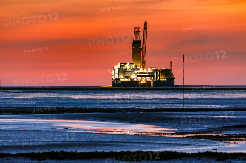 View from the Trischendamm to Germanys only drilling platform Mittelplate after sunset at low tide