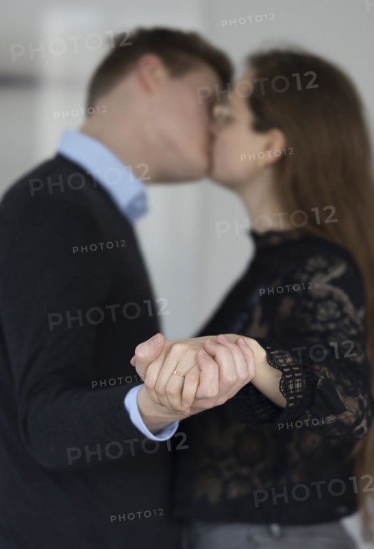 Young couple with engagement ring.