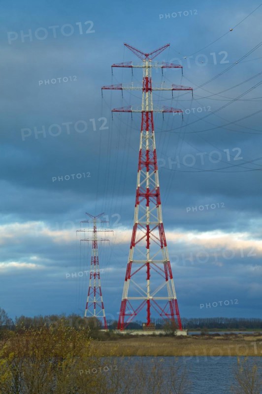 Red and white marked electricity pylons on the Lower Elbe near Stade