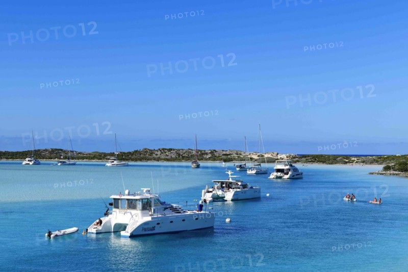 Sailboats and catamarans anchor off Warderick Wells