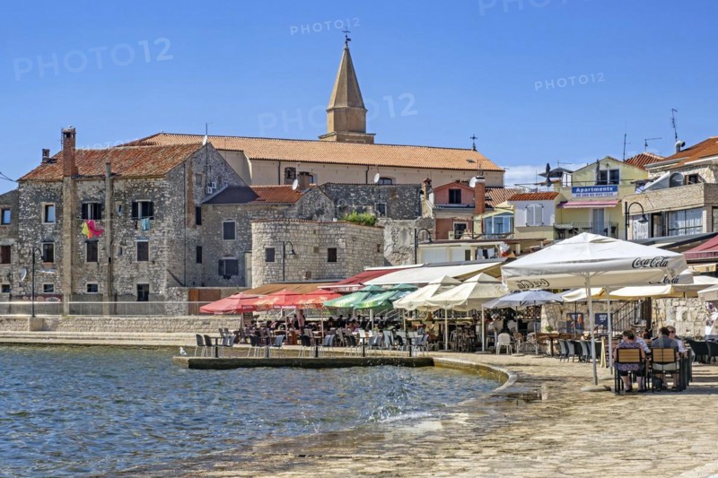 Terraces of restaurants along the waterfront in the town Umag