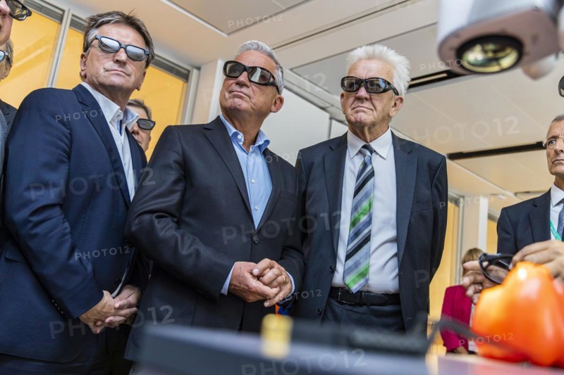 Three ministers wearing black 3D glasses. From right