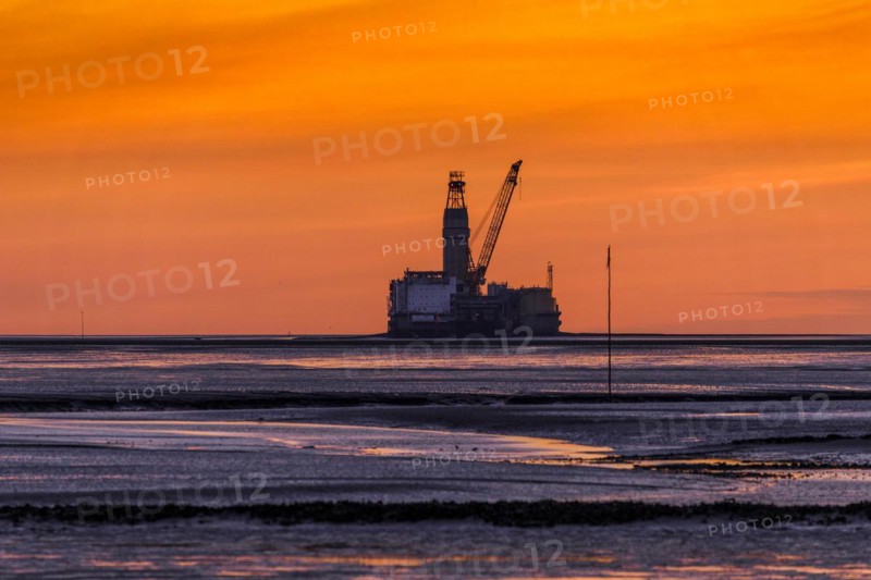 View from the Trischendamm to Germanys only drilling platform Mittelplate after sunset at low tide