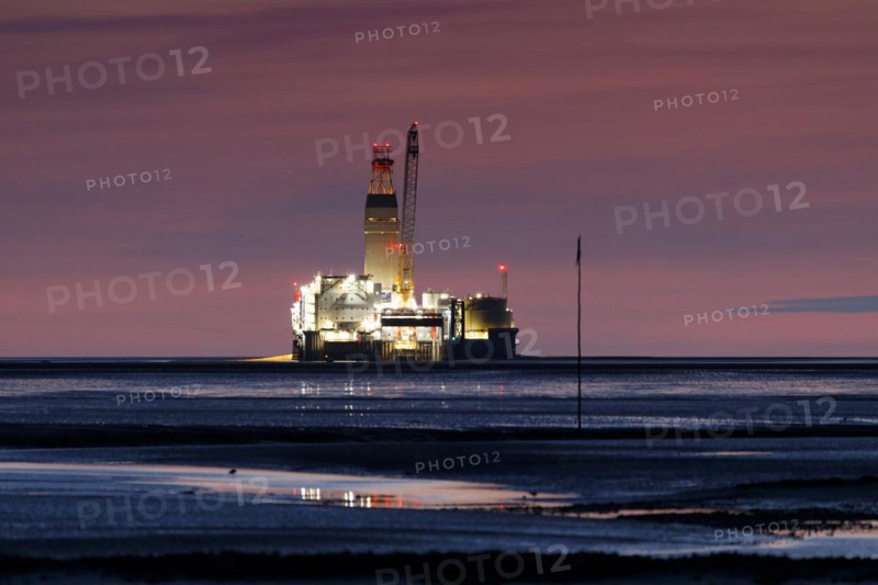 View of Germanys only drilling platform Mittelplate at night and low tide from the Trischendamm