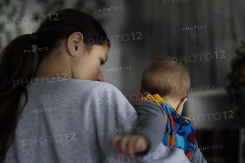 Girl with baby in her arms