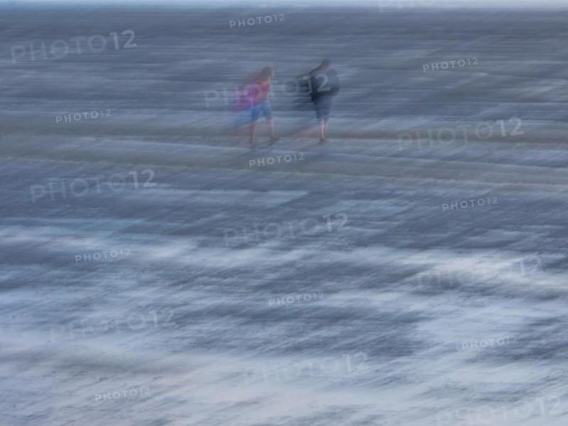 Two people in the mudflats