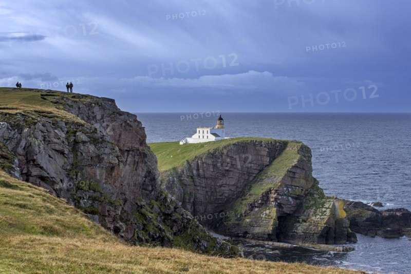 Walkers and the Stoer Head Lighthouse at the Point of Stoer in Sutherland