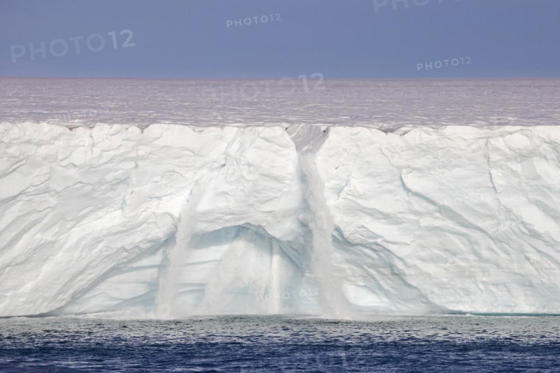 Waterfalls at edge of the Brasvellbreen glacier from the ice cap Austfonna debouching into the Barents Sea