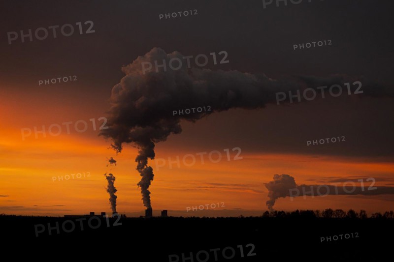 The Boxberg coal-fired power plant looms in the evening twilight near Ober-Prauske