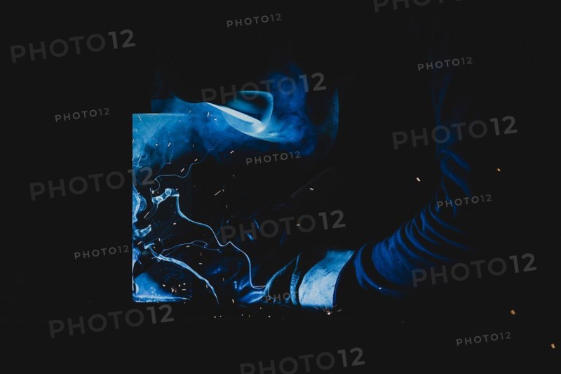 A metal worker welds metal