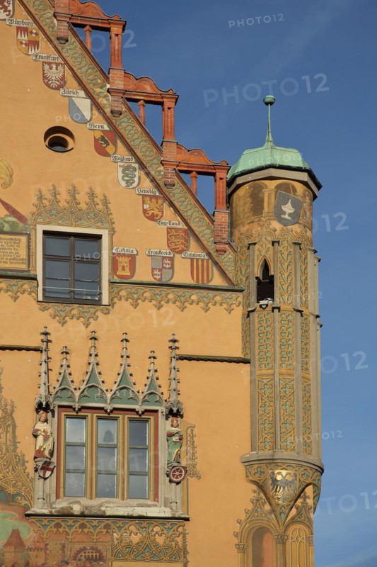 Ornate gable with bay window and mural of city arms on the town hall