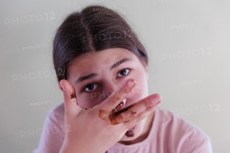 Girl with a chocolate-smeared mouth