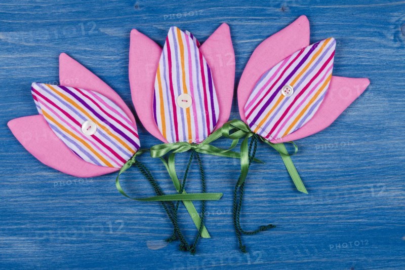 Three fabric tulips on a blue background