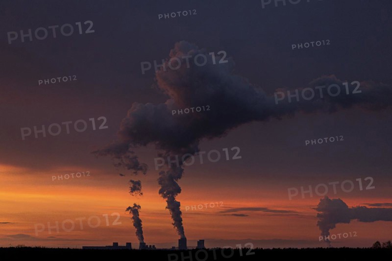 The Boxberg coal-fired power plant looms in the evening twilight near Ober-Prauske