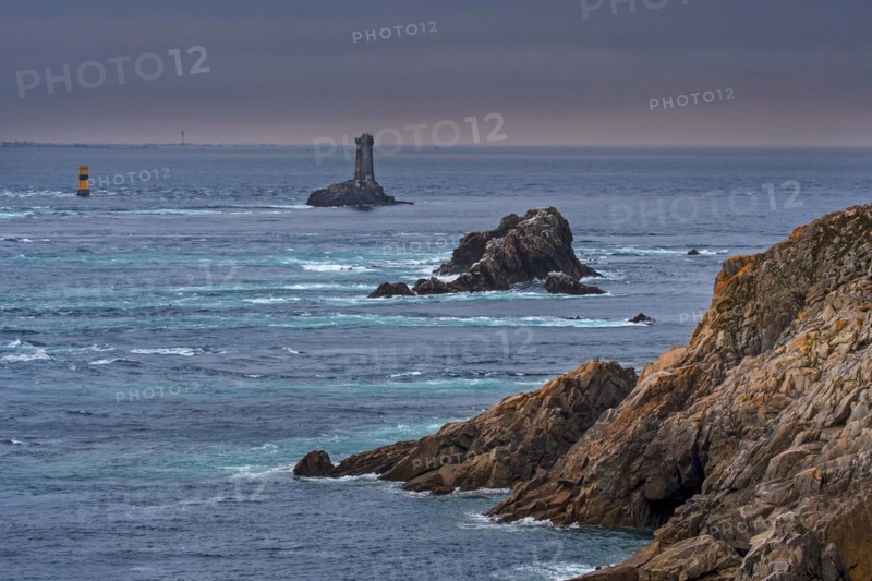 The lighthouse La Vieille in the strait Raz de Sein at dusk at the Pointe du Raz