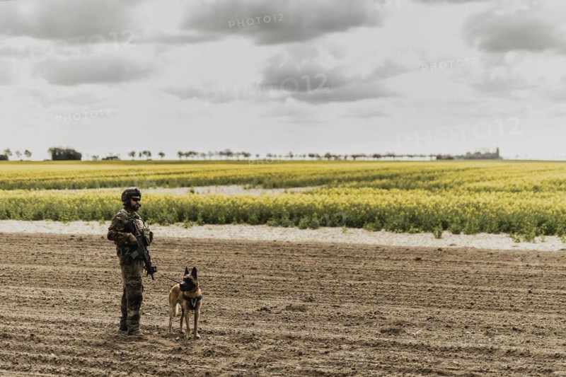 A soldier of the German Armed Forces with a mission dog