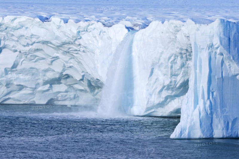 Waterfalls at edge of the Brasvellbreen glacier from the ice cap Austfonna debouching into the Barents Sea